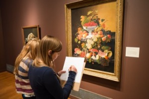 Biology students examining paintings at the Reynolda House Museum of Art