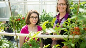 Kathleen DiNapoli (left) and Dr. Gloria Muday in the Biology greenhouse showing their heirloom specimens